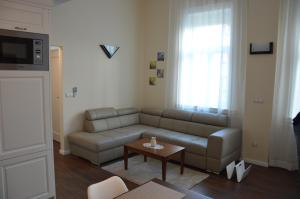 uma sala de estar com um sofá e uma mesa em M2-Apartment em Szombathely