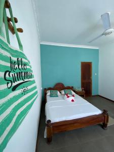 a bedroom with a bed with a sign on the wall at Pumzika Kendwa Villa in Kendwa
