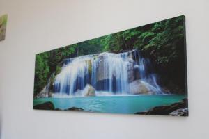 a picture of a waterfall hanging on a wall at Dolci Paesaggi in Marausa