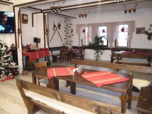 a dining room with tables and chairs and a christmas tree at Guest House Belchin View in Belchin