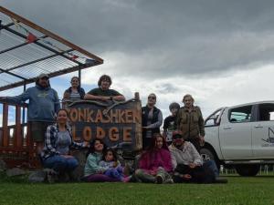 people posing for a picture in front of a truck at Konkashken Lodge in Torres del Paine