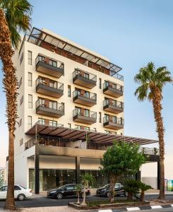 a building with cars parked in front of it at Mr. Soof - By TLV2GO in Eilat