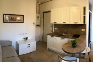 uma cozinha com um lavatório e uma mesa num quarto em Il Bosco - vicino al lago, vicino alle montagne em Ballabio