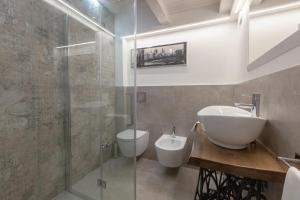 a bathroom with a sink and a toilet and a shower at Loft-Relax in Bologna
