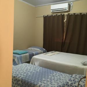 Una cama o camas en una habitación de CASA DE TEMPORADA NO JALAPÃO (CAP 11 PESSOAS)