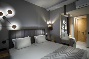 Ένα ή περισσότερα κρεβάτια σε δωμάτιο στο Palmera Beach Hotel & Spa - Adults Only