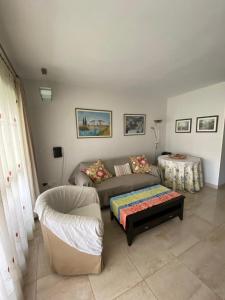 a living room with a couch and a table at Apartamento Aguamar in Denia +17 photos