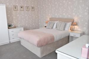 a bedroom with a large bed with two night stands at The Castleton in Swanage