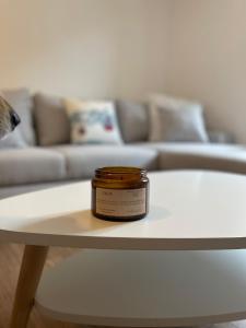 a jar of honey sitting on a table in a living room at Appartement idéalement situé Ax-les-thermes in Ax-les-Thermes