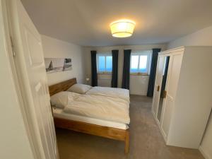 1 dormitorio con 1 cama y una luz en el techo en FeWoEck Kogge en Eckernförde