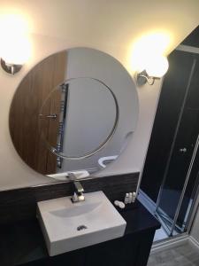 a bathroom with a sink and a large mirror at The Tack Room in Inverness