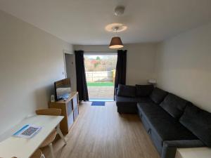 a living room with a couch and a table at Arragon Short-Stay Apartments in Waterlooville
