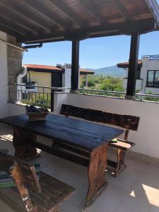 a wooden table on a balcony with a view at Family Hotel Littoral in Sozopol