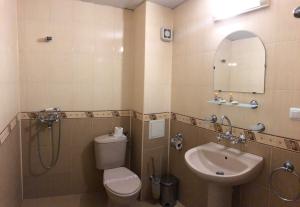 a bathroom with a toilet and a sink at Family Hotel Littoral in Sozopol +48 photos