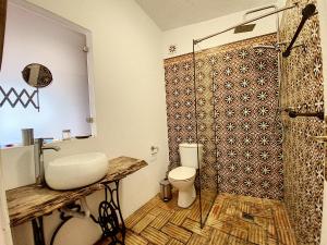 a bathroom with a toilet and a sink at Monte Do Malhao - Art, Eco & Spa in Castro Marim