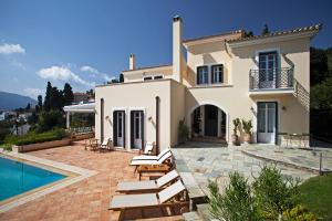 a villa with a swimming pool and a house at Hortensia Villa - Infinity Pool & Sea Views by Explore Andros in Andros