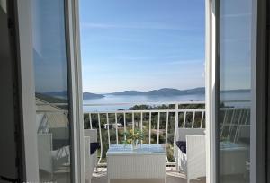 a view of the ocean from the balcony of a house at Apartment Lucija with sea view in Dubrovnik