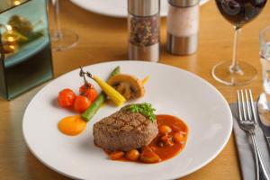ein Teller mit Fleisch und Gemüse auf dem Tisch in der Unterkunft Hotel Zeezicht in Oost-Vlieland