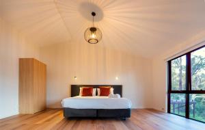 a bedroom with a bed and a large window at Marramarra Lodge in Bar Point