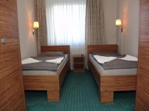 En eller flere senge i et værelse på City Hotel Ansbach am KaDeWe
