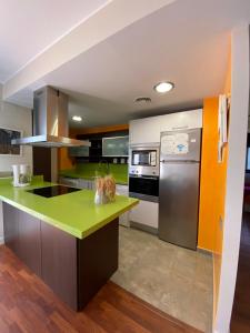 a kitchen with a green counter top and a refrigerator at Lo Raconet in Deltebre