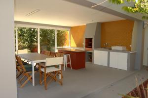 a kitchen with a table and chairs in a room at Consuls Residence in Ponta Delgada