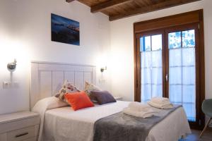 a bedroom with two beds with towels on them at Apartamentos Rurales Camín Real in La Caridad