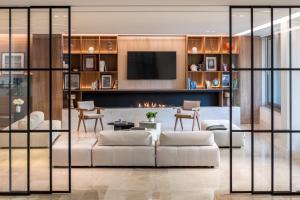 a living room filled with furniture and a large window at Amarilia Hotel in Athens
