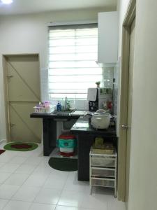 a kitchen with a sink and a counter top at Laman Hanaz - Changloon in Changlun