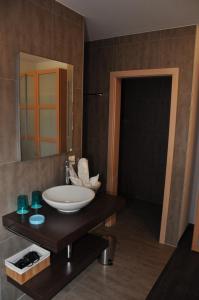 a bathroom with a sink and a mirror at Le Relais du Château Monney in Cournillens