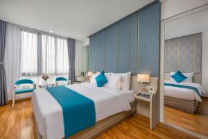 Letto o letti in una camera di Calix Hotel Da Nang Beach