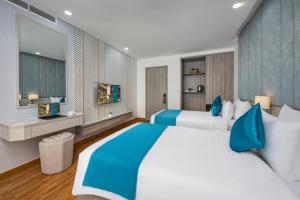 Letto o letti in una camera di Calix Hotel Da Nang Beach