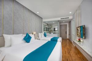 Letto o letti in una camera di Calix Hotel Da Nang Beach