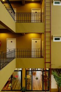 a spiral staircase in a building with two doors at Jerung Hotel in Khao Lak