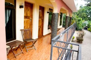 a balcony with two chairs on a house at Bright Star Hotel in Arusha
