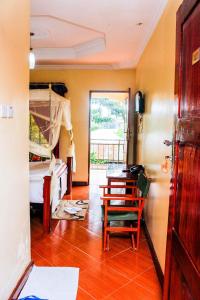 a room with a bedroom with a table and a bed at Bright Star Hotel in Arusha