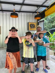 a group of people standing together in front of a building at BeachBox@Koh Сhang in Ko Chang