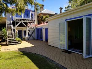 a house with a patio and a staircase next to it at City central apartment – modern, private & quiet in Invercargill