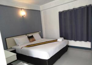 a bedroom with a large bed in a room at NorthLands House Hotel in Chiang Mai