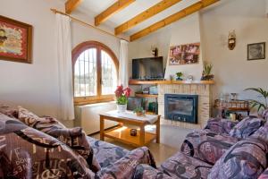 a living room with two couches and a fireplace at Villa Odisea in Calpe