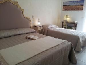 Postel nebo postele na pokoji v ubytování Dimora delle Rondini