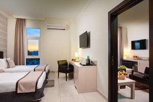 a hotel room with a bed and a desk at City Hotel Duqm in Duqm