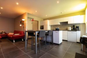 a kitchen with a table and chairs in a room at Ter Ename 3 in Oudenaarde