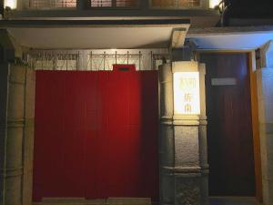 a red door in a building with a sign on it at FunNan Guesthouse in Tainan