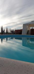 a swimming pool with a tent in the middle of it at Casa rural Vega alta in Madridejos