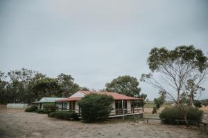 a house with a red roof in a field at Alkoomi Chalets in Frankland +3 photos