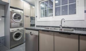 a kitchen with a sink and a washer and dryer at R114 Apartment Ca La Laura in Calafell