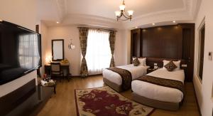 Rúm í herbergi á Maya Manor Boutique Hotel by KGH Group