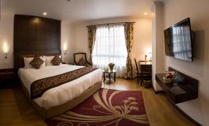 Rúm í herbergi á Maya Manor Boutique Hotel by KGH Group