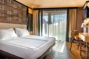 A bed or beds in a room at Eurostars Sofia City